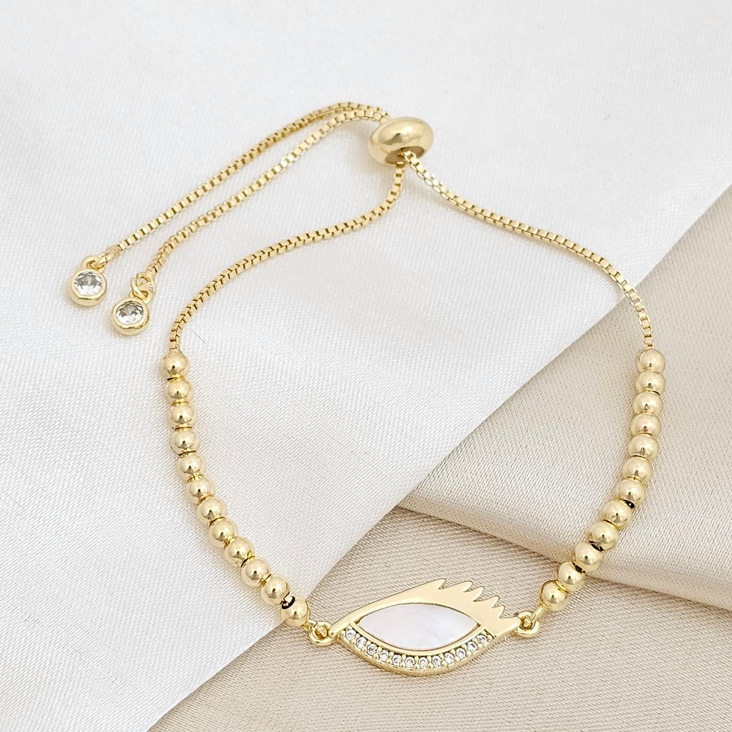 PULSERA CORREDIZA BALINES CON DIJE OJO NACAR Y CIRCONES RF K6734
