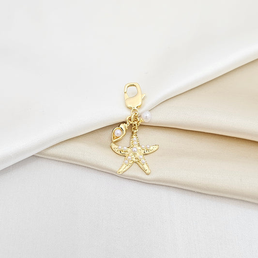 LLAVERO ESTRELLA DE MAR Y MINI CARACOL PERLAS DORADO RF K6937