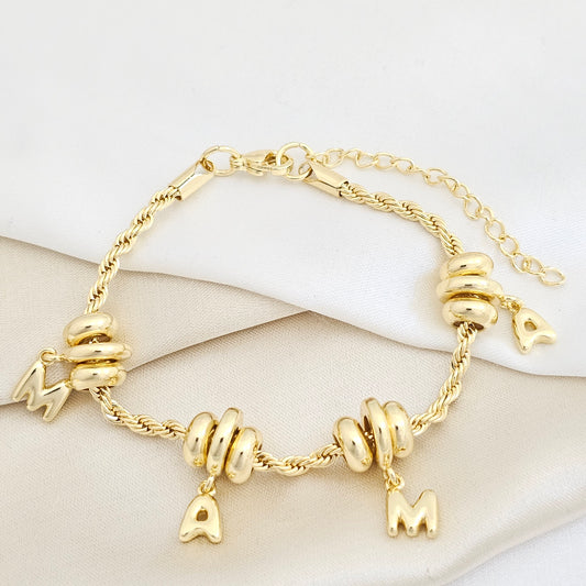 PULSERA LAZO CON DIJES PALABRA MAMA EXTENSOR DORADO RF K7723