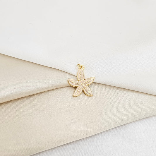 DIJE ESTRELLA DE MAR BLANCO Y DORADO RF K7132