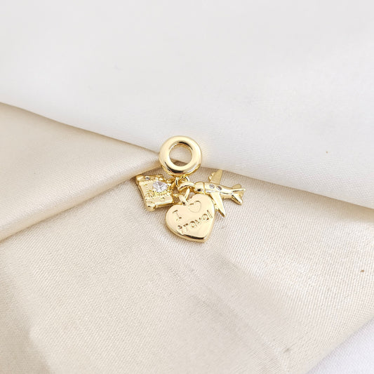 CHARM CORAZON AVION Y MALETA DORADO RF K7793