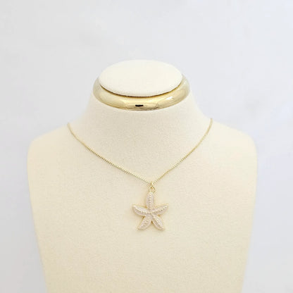 Dije Estrella De Mar Blanco Y Dorado Rf K7132