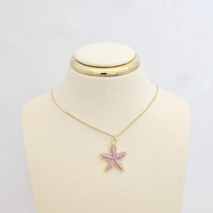 Dije Estrella De Mar Lila Y Dorado Rf K7134